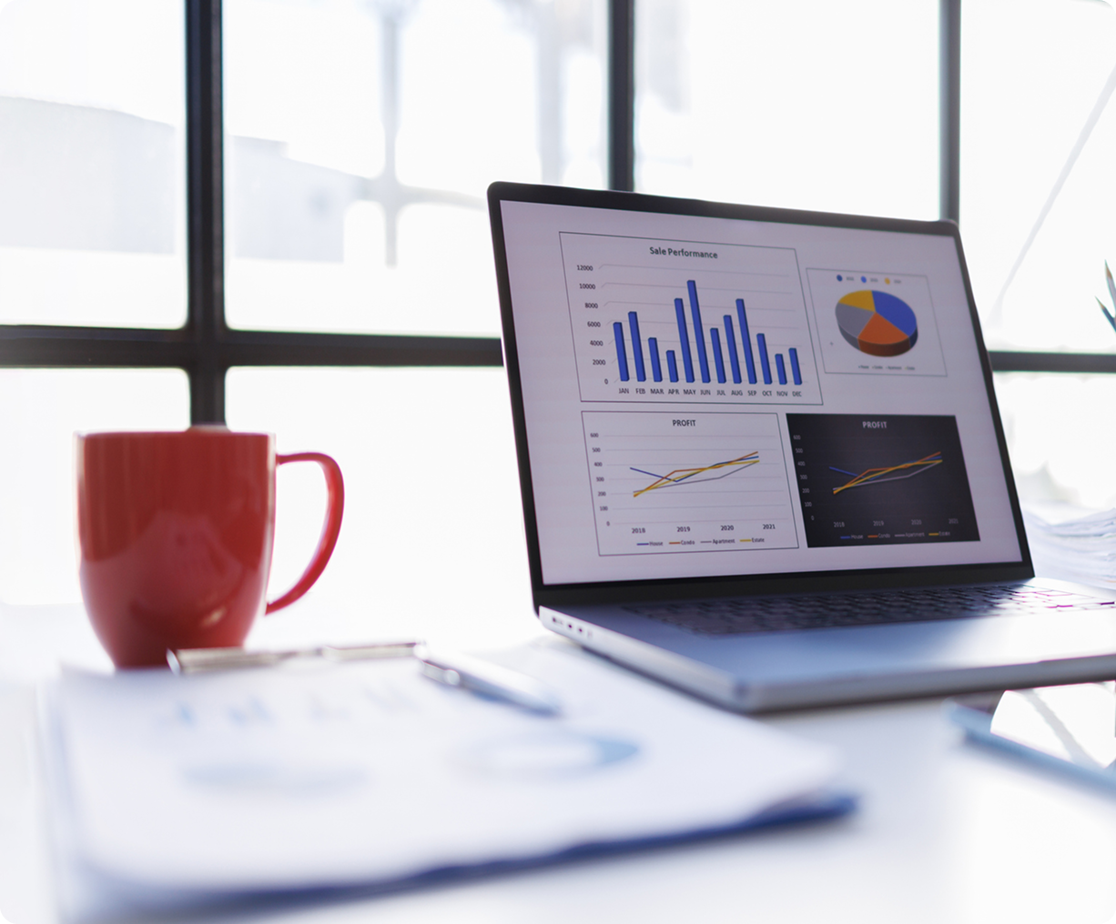 Laptop displaying sales charts and graphs