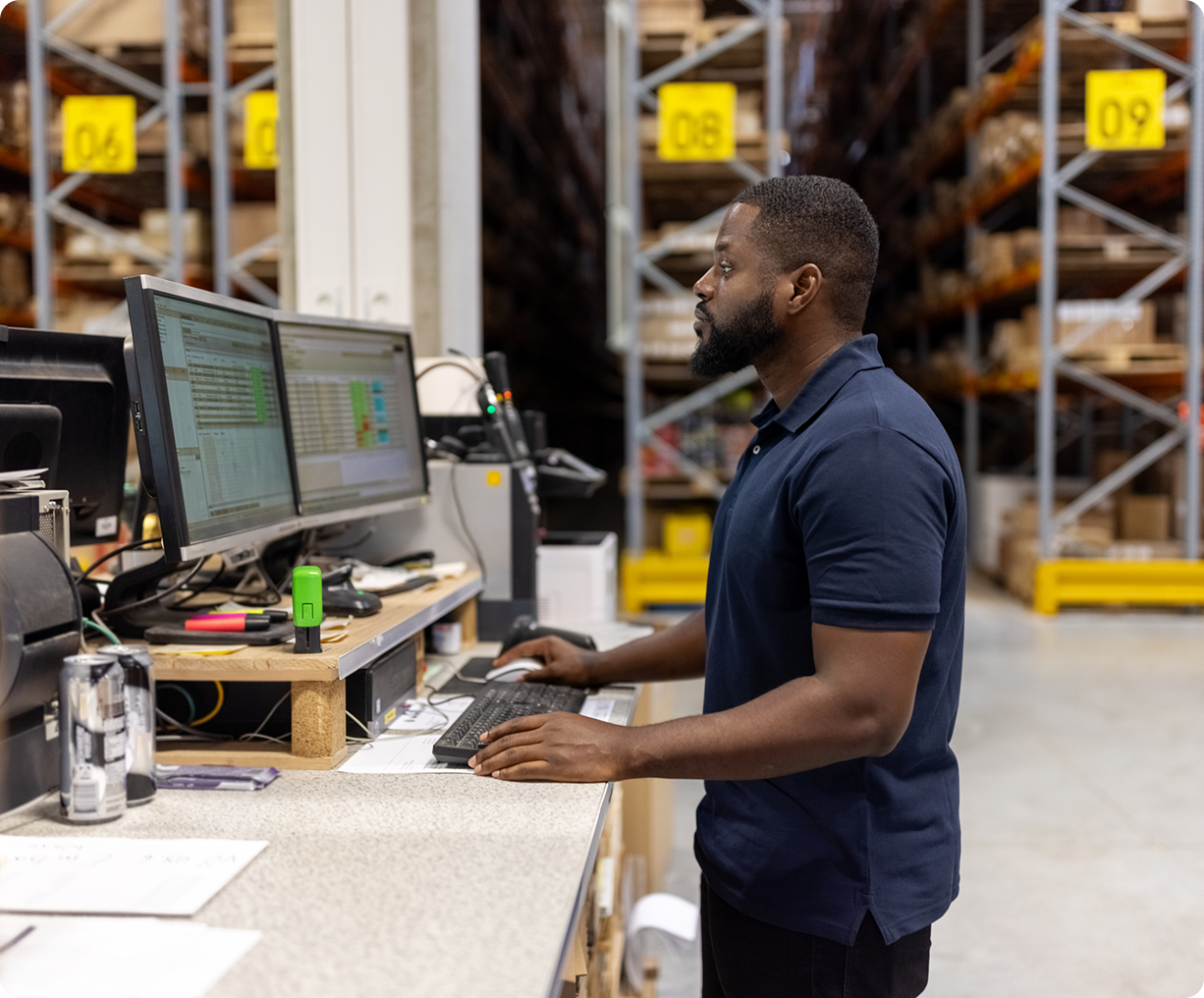 Man managing inventory in warehouse