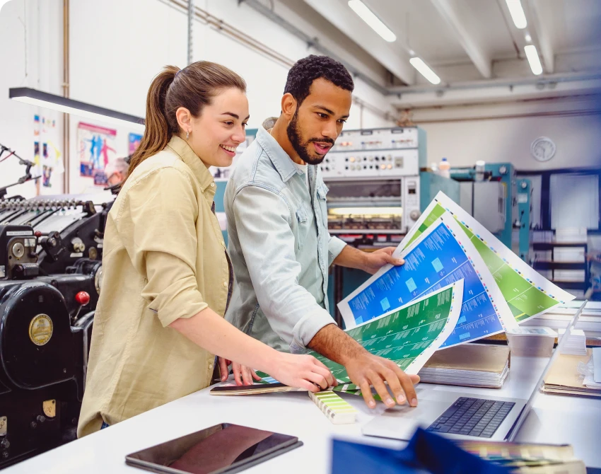 Colleagues examining large print sheets